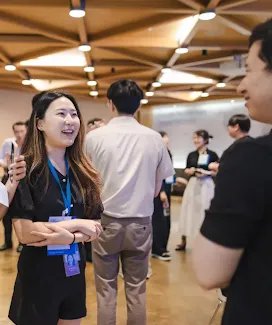 Woman smiling and discussing with a man.