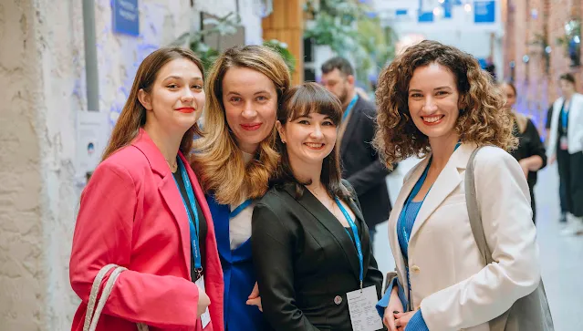 4 Ladies are looking giving pose for photo.