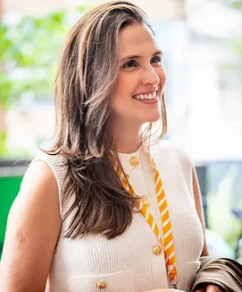 Close-up of a woman with an ID badge engaging in conversation.