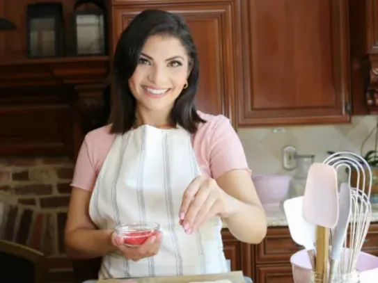 Alex George adding sprinkles to fresh-baked pastries