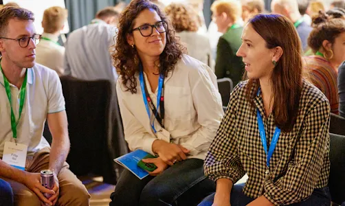 2 women and a man discussing