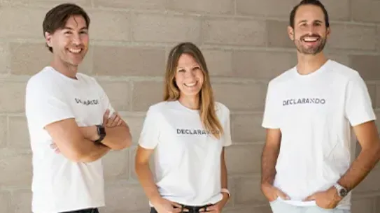 Founding team members of Declarando are posing against a wall with matching shirts.