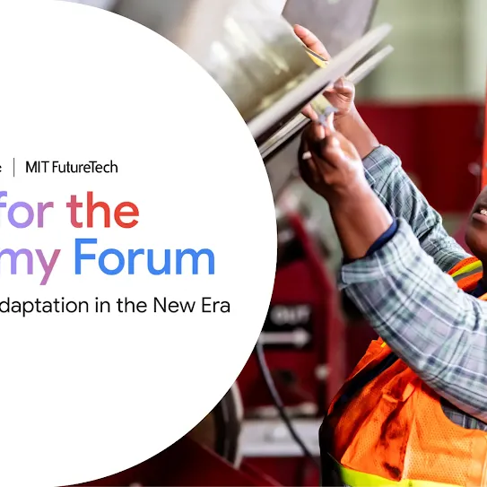 A woman wearing safety glasses and a grey hoodie operates a heavy-duty yellow Powermatic drill press in a well-lit manufacturing facilit