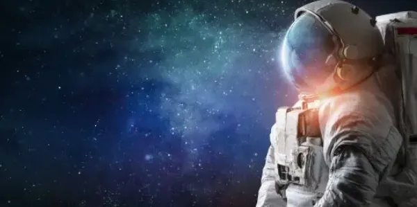 astronaut in space suit looking into space
