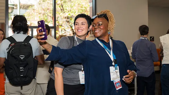 Two people at a workshop taking a selfie together