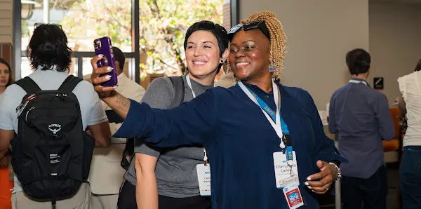 Two people at a workshop taking a selfie together