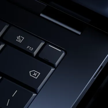Close-up of the Googlebook keyboard corner showing the power button, volume keys, backspace key, and speakers.