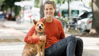 Dogo Founder, Rasa, and her dog, Ūdra, smile for the camera.