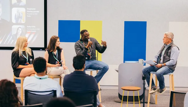A panel of professional is discussing ideas and sharing insights during a conference. session in front of an engaged audience.