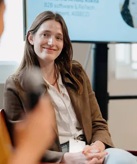 Woman smiling and facing the camera.