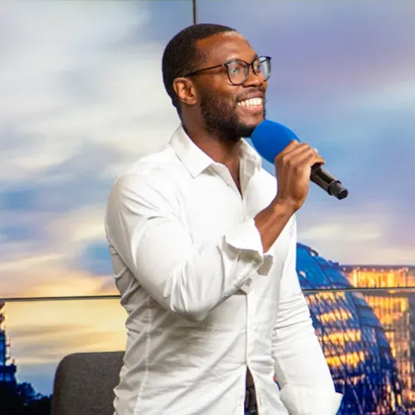 A guy speaking in mic smiling