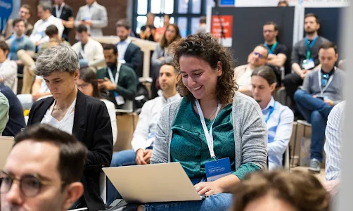 A team is sitting in a conference room.