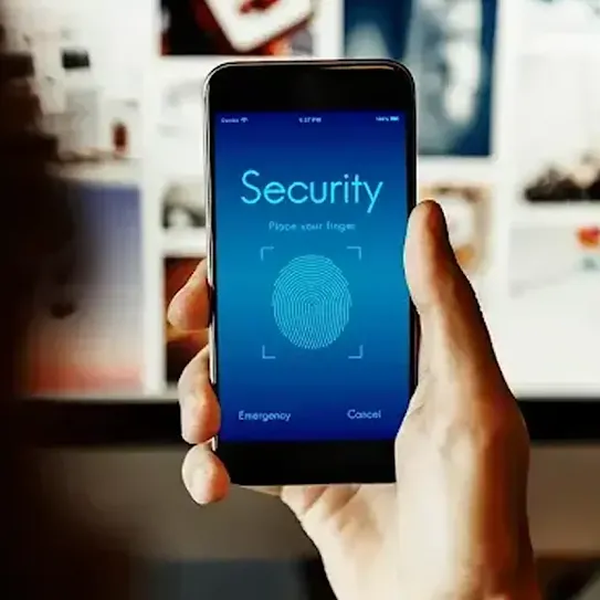 A hand holds a smart phone on which an ombré blue background is displayed. The words ‘security’ and ‘place your finger’ appear above a thumb print that indicates the biometric access protections available on this device.