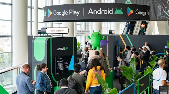 Photo of the Google Play and Android booth at the Game Developers Conference, with attendees interacting with demo stations and displays.