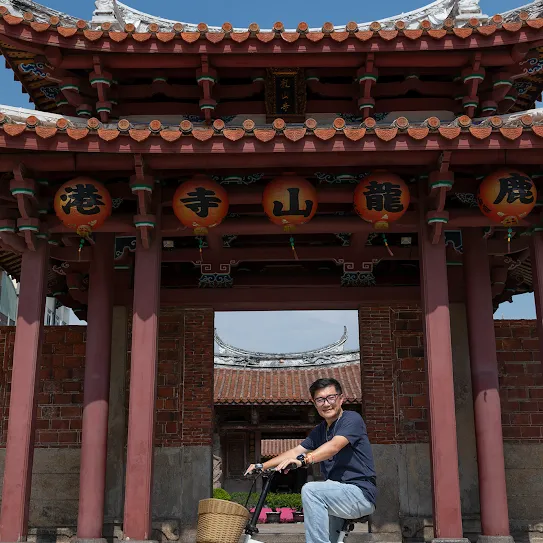 Googler Jerry Kuo sits on a bike in front of a temple in Changhua County, Taiwan
