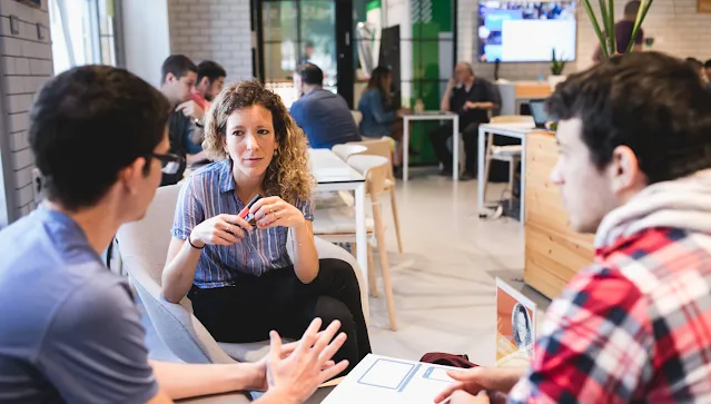 2 men and a woman discussing