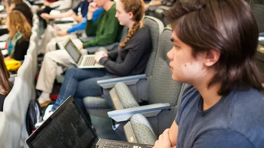 Several students seated in a lecture hall