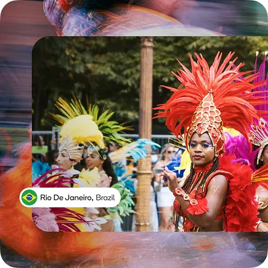 Festival dancers in feathered costumes performing during Rio de Janeiro carnival parade managed by Waze Event Partners