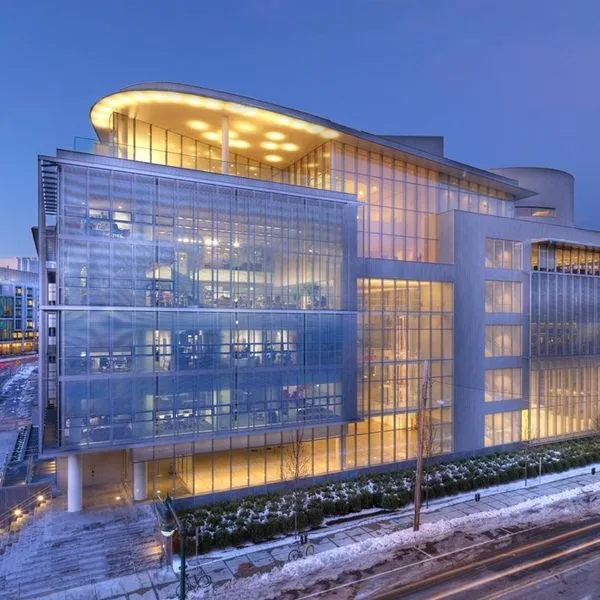 A modern office building surrounded by a city during the winter