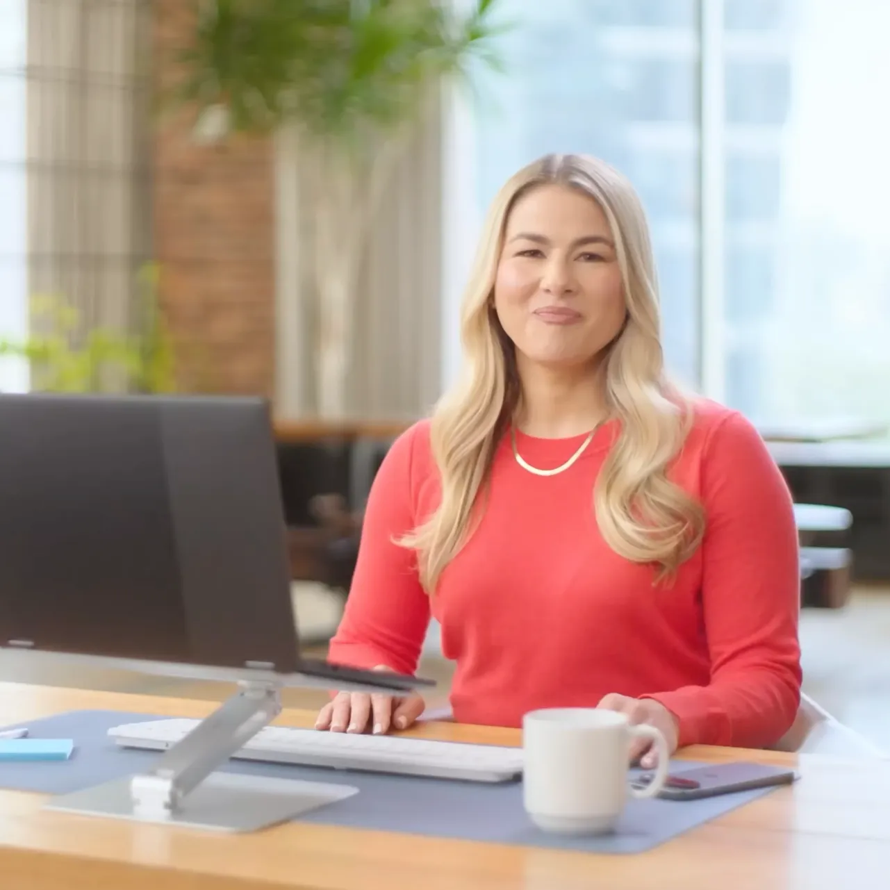 A person is seated at a desk with a monitor on top, eager to teach how AI will work for you.