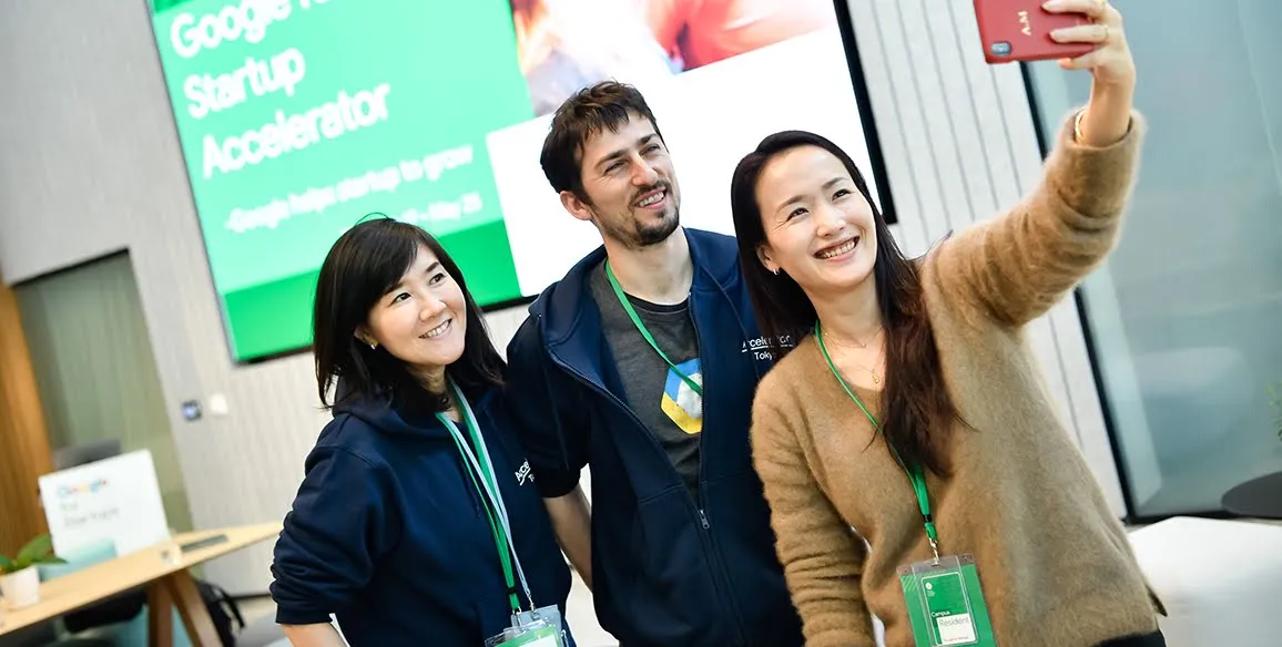 The Baobab team takes a selfie in front of the Google for Startups Accelerator sign.