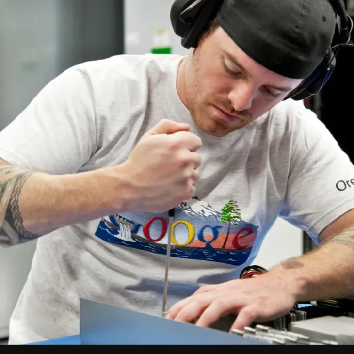 A person works with a tool to fix a piece of hardware