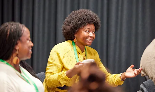A man and woman watching on their laptops.
