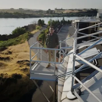 A thumbnail image of a person standing on a metal platfrom in an industrial setting.