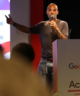 A person is hosting the event and currently speaking into the microphone.