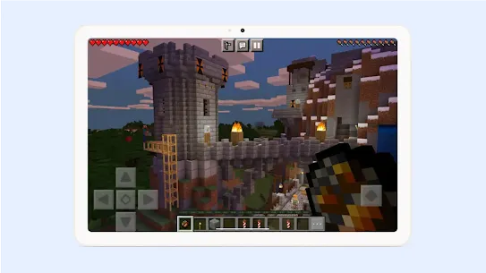 A tablet screen displaying a cobblestone castle from Minecraft.