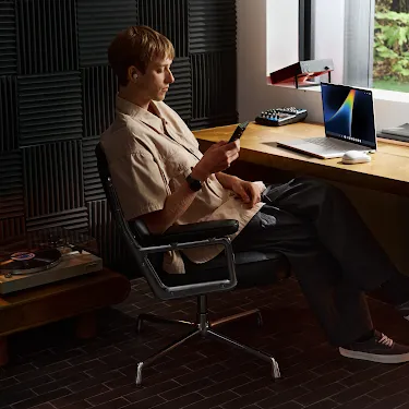 Person working on a Googlebook in a music studio.