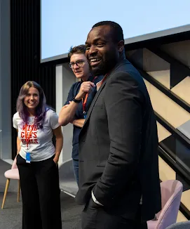 Woman chatting with a man, smiling.