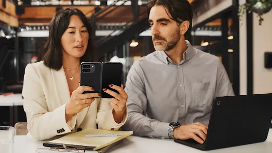 Image of a woman using her phone at a cafe