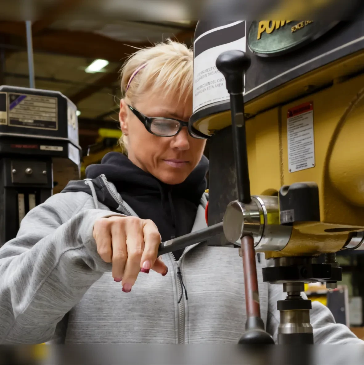 Woman using a manufacturing tool
