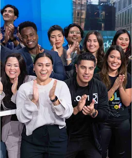 A group of people clapping and smiling.