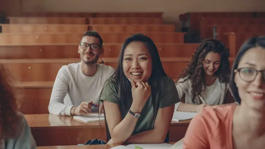 Asian female student smiling in university lecture hall.