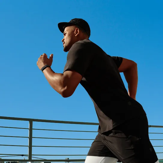 A man runs along a sidewalk