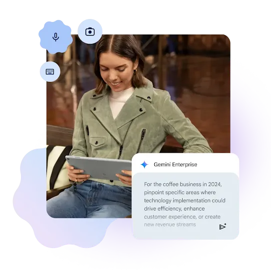 A woman with short brown hair is smiling while looking at a light grey tablet held in her hands. She is wearing a sage green suede biker jacket over a white top and blue jeans. Overlaid on the image are several icons—a microphone, a camera and a keyboard as well as a chat window labeled "Gemini Enterprise" containing text about driving efficiency and revenue for a coffee business in 2024.