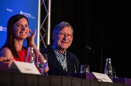 Cisco’s Katie Shay and Google’s Hal Varian smiling while seated on a panel at the TPI Aspen Forum.