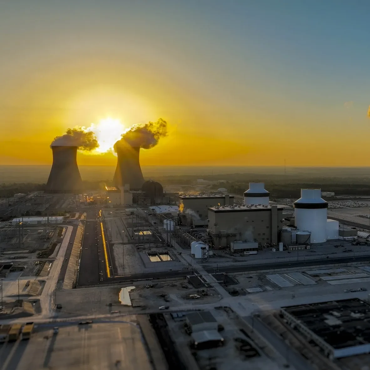 Nuclear power plant with sunrise in the background