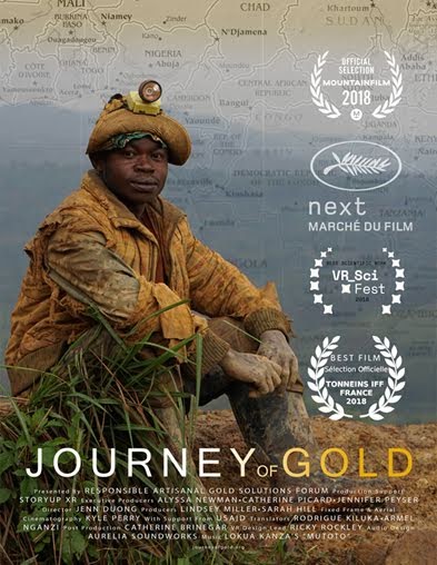 A miner resting with their arms on their knees and looking directly at the camera.