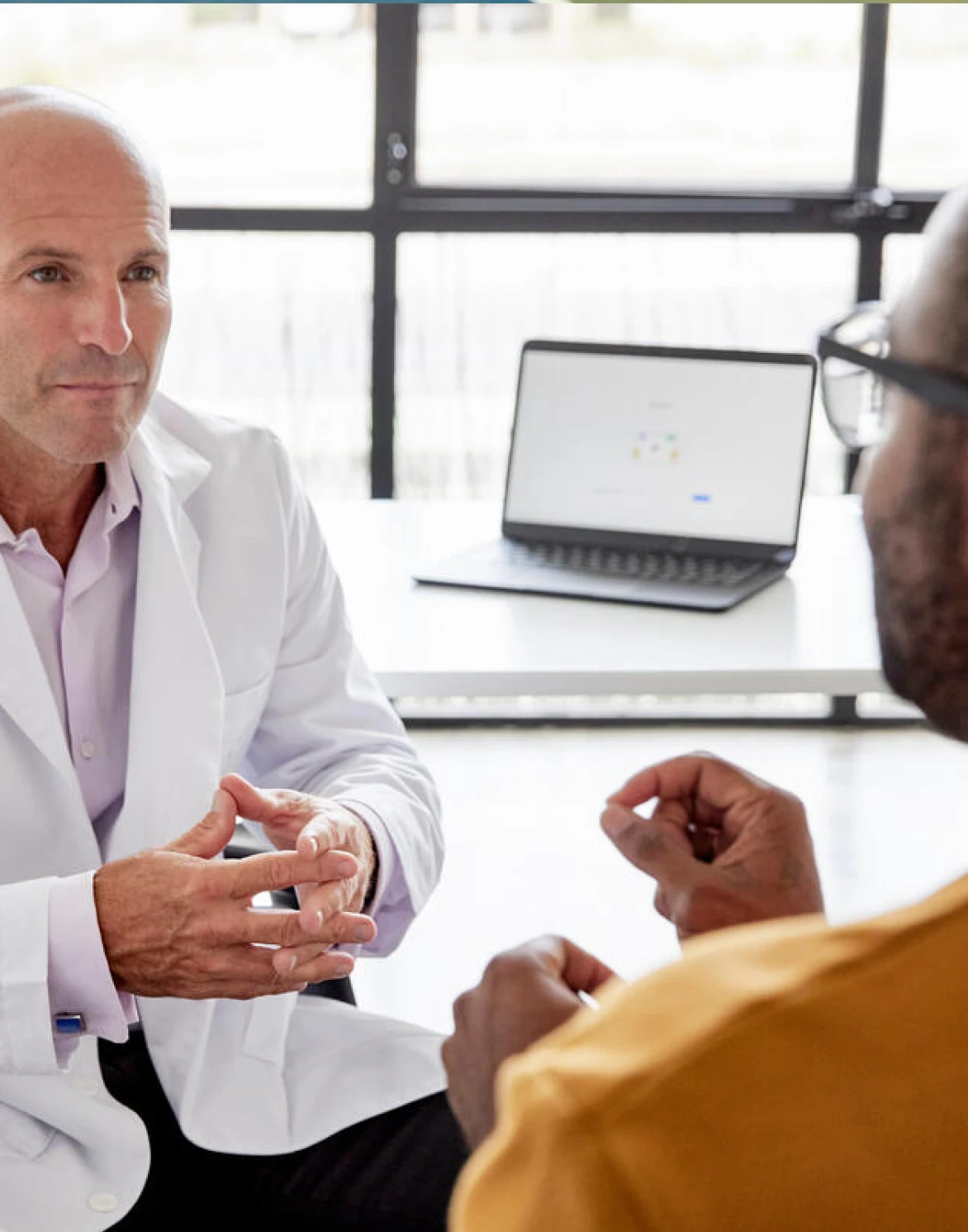 Image of man and doctor discussing health