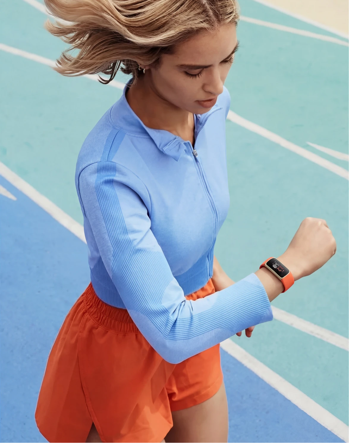 Image of woman running wearing Fitbit Charge 6. 