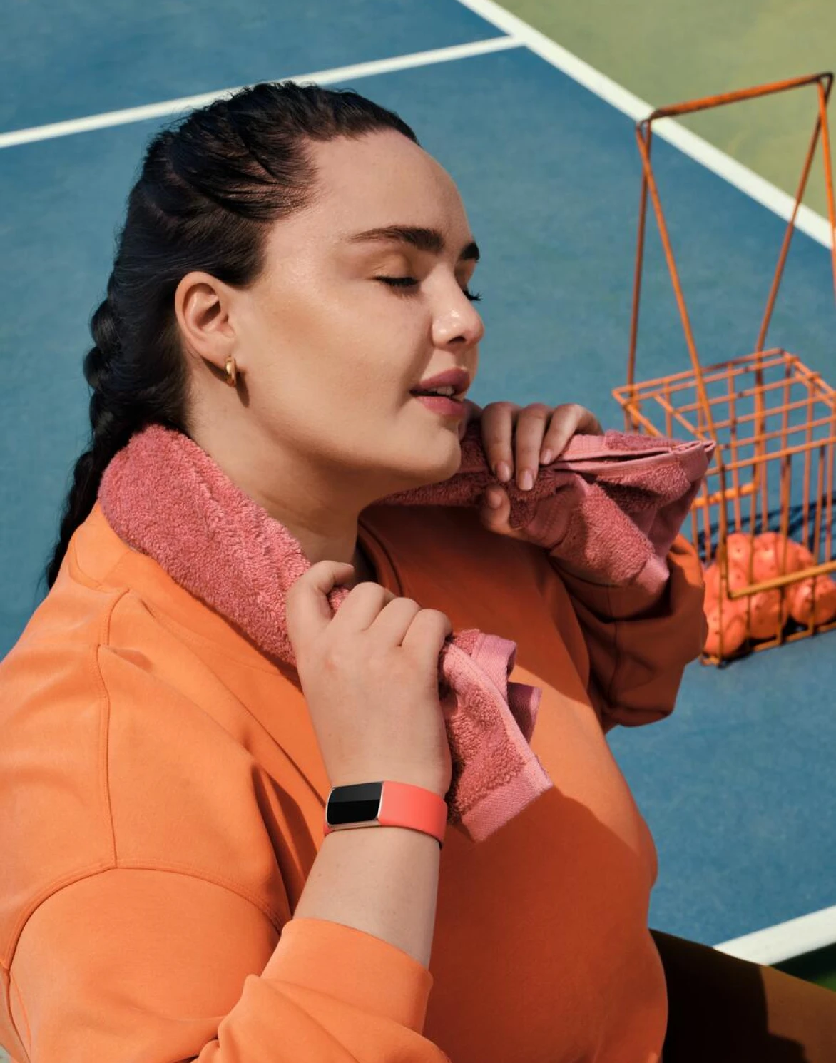 Image of woman playing pickleball wearing Fitbit Charge 6